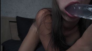 Brunette slobbering sucks a huge dildo and fucks herself